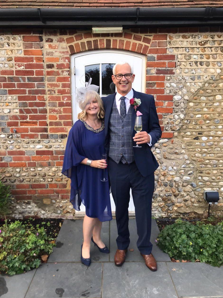 Photo of a couple of guests at a wedding, with woman wearing Sargasso & Grey Shoes